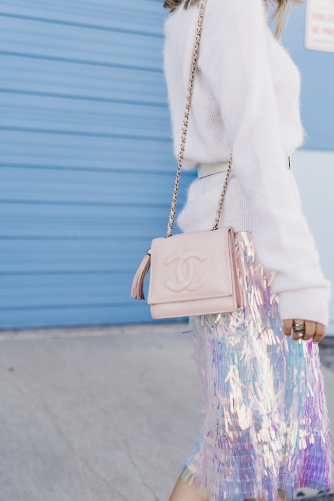 light-pink-chanel-shoulder-bag-against-blue-background