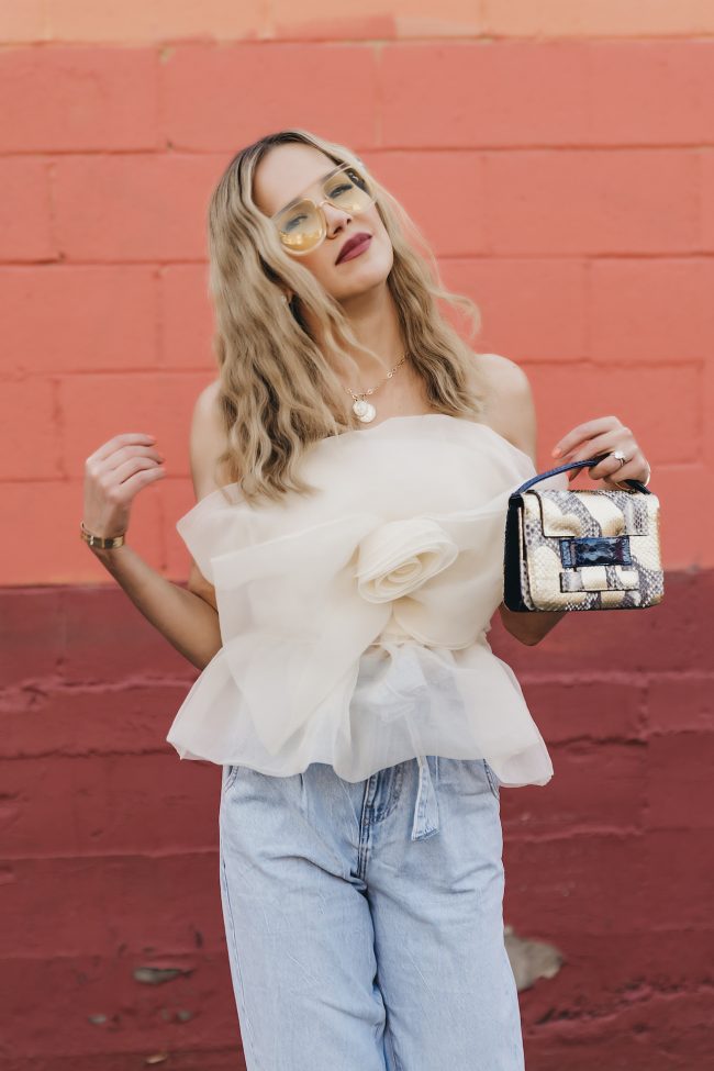 Angie Harrington fashion blogger wearing metalskins bag and light wash denim