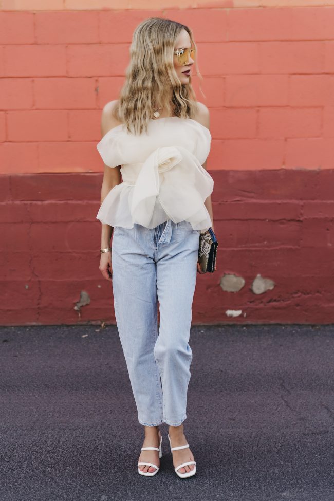 Angie Harrington fashion blogger wearing a tube top statement piece with light wash denim