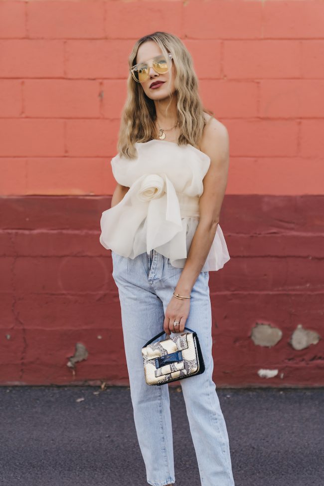 Fashion blogger wearing a neutral and whimsical top with denim