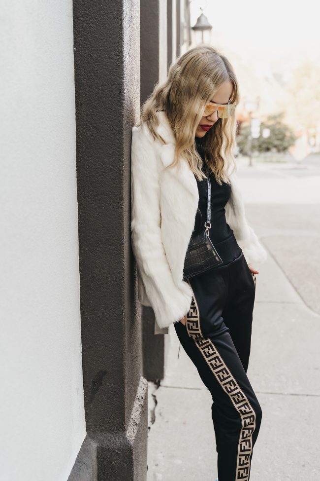 Street style blogger featuring fendi joggers and a white jacket