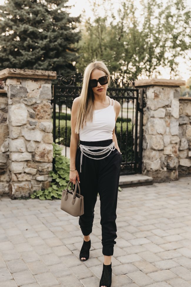 Fashion blogger wearing a white tank and black joggers for date night or GNO 