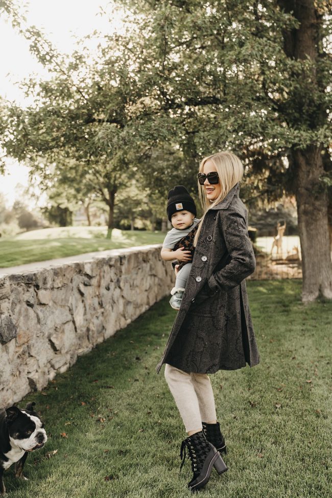 street style blogger wearing a transitional outfit for fall and winter with baby carrier is artipoppe
