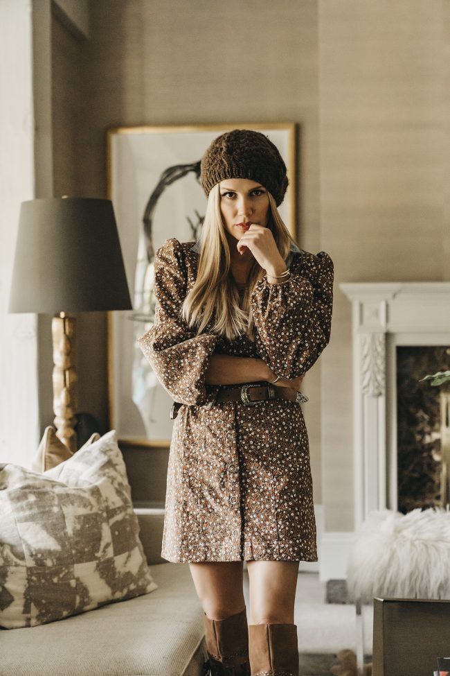 Street style blogger wearing a brown polka-dot dress and a brown belt